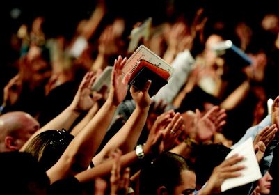 Youth pastor sitting with kids on stage