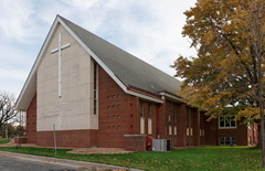 Front of  Gospel Church with cross and name.